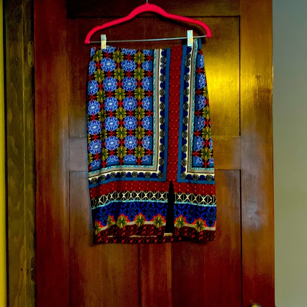 Maeve pencil skirt with zip in the back, slit on left leg, slight stretch.